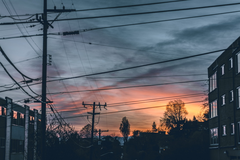 architecture, building silhouette, power lines, azure sky, tree, low angle view, connection, nature, cable, neighborhood, complexity, built structure, sunrise