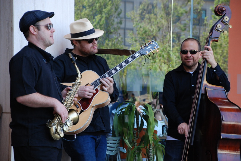 people, musical instrument, guitar, holding, arts culture and entertainment, playing, men, performance, jazz, clothing, string instrument, artist, performance group