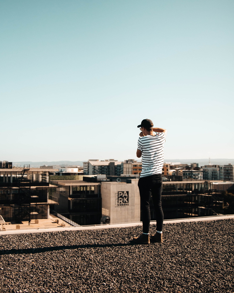 built structure, city, sky, sunlight, full length, one person, men, day, tarmac, south africa, rear view, nature, building exterior, road, spire, dirt road