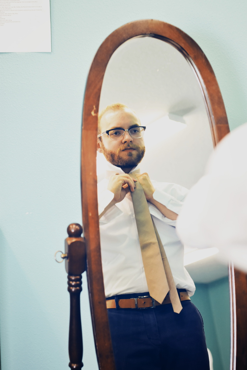 wedding attire, holding, standing, males, front view, wedding prep, young adult, tie, mirror, portrait, glasses, suit, getting ready, real people, healthcare and medicine