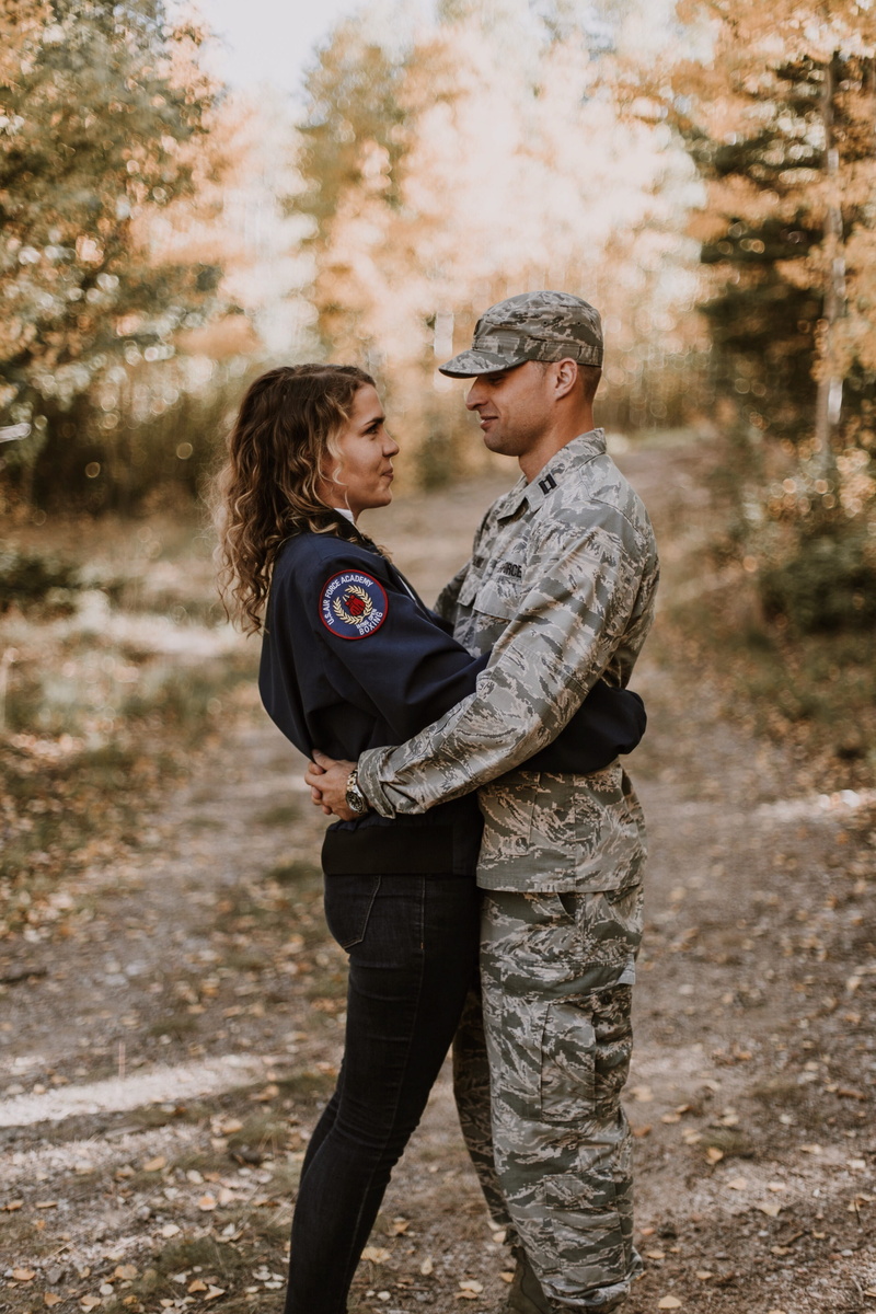 focus on foreground, togetherness, young adult, two people, positive emotion, males, field, day, man, tree, plant, couple, woman, wear, uniform, hairstyle