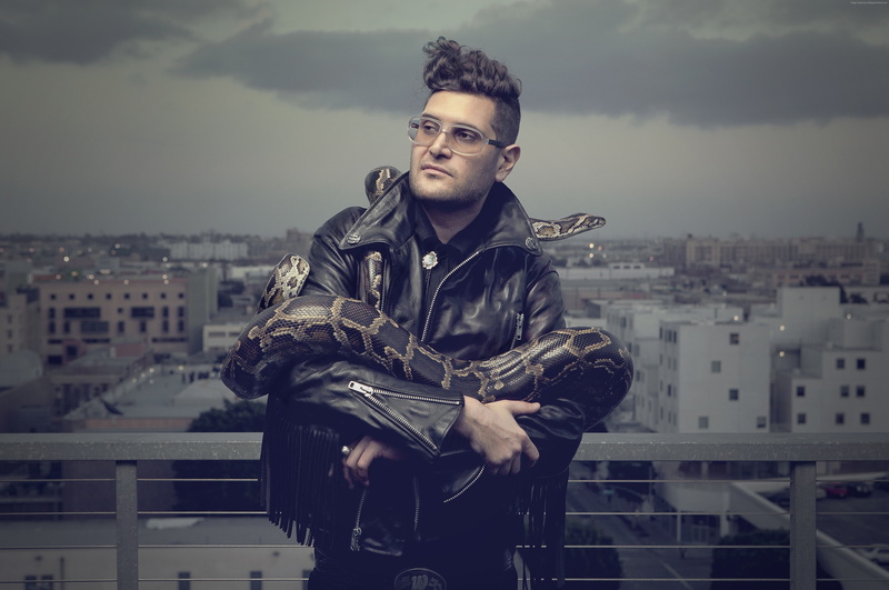 day, cityscape, sky, young men, actor, 5K, front view, building exterior, clothing, one person, leather jacket, building, portrait, city life, city, looking at camera