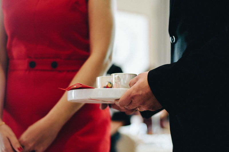 holding, indoors, reception, lifestyles, close-up, red, incidental people, restaurant, women, adult, couple - relationship, serving food and drinks, beautiful