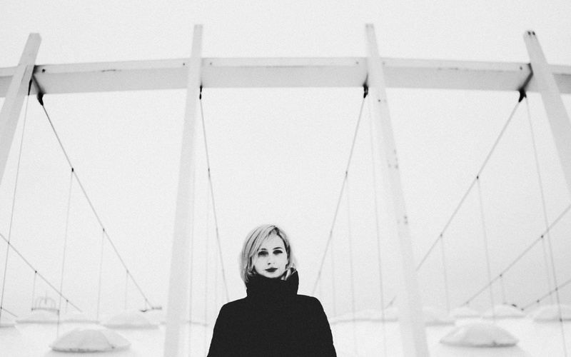 headshot, one person, female, strcuture, performer, casual clothing, looking, contemplation, lifestyles, building, day, looking at camera, adult, face