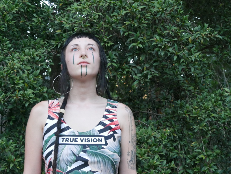 standing, wearing, real people, united states, text, tank, young women, looking, outdoors, los angeles, looking up, clown, performer, front view, beautiful woman