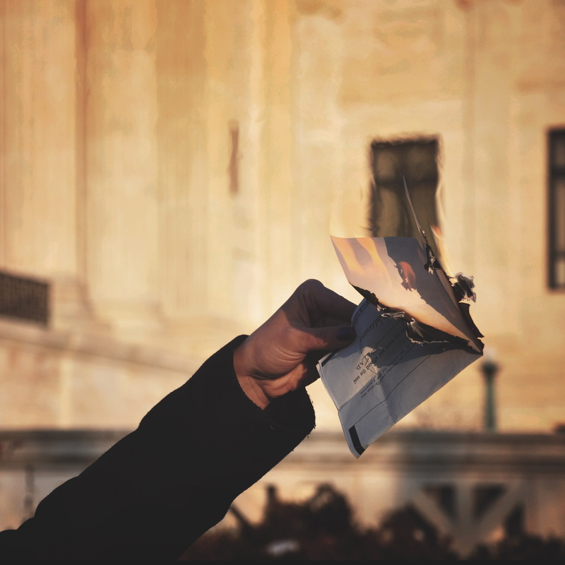 outdoors, advertisement, hand, money, flyer, protest, washington, united states, men, supreme court of the united states, person, brochure, burn, human hand