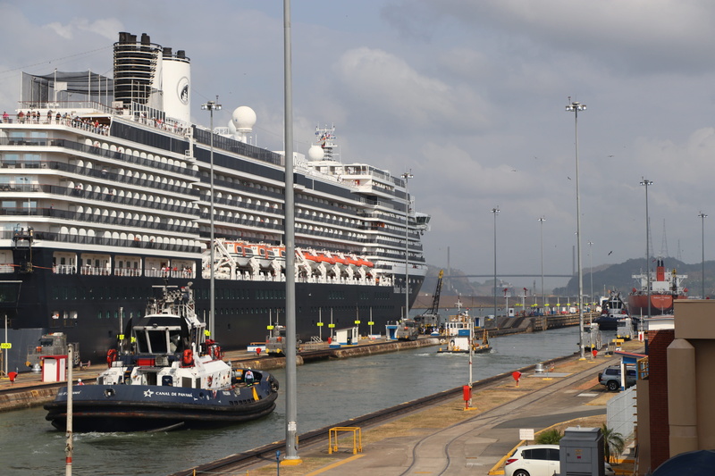 sky, city, motor vehicle, built structure, mode of transportation, land vehicle, ship, nautical vessel, office building exterior, street, road, panama canal