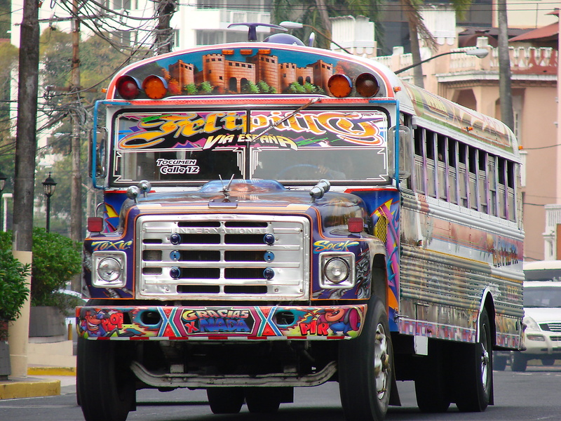 day, no people, mode of transportation, bus, panama, nature, city, car, text, western script, stationary, street, transportation, service bus, architecture