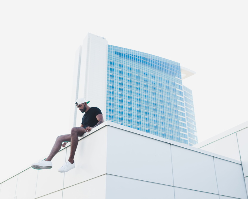 adult, skyscraper, outdoors, young male, lifestyles, mens fashion, young Adult, day, males, roof, city Life, building Exterior, modern, sitting, occupation
