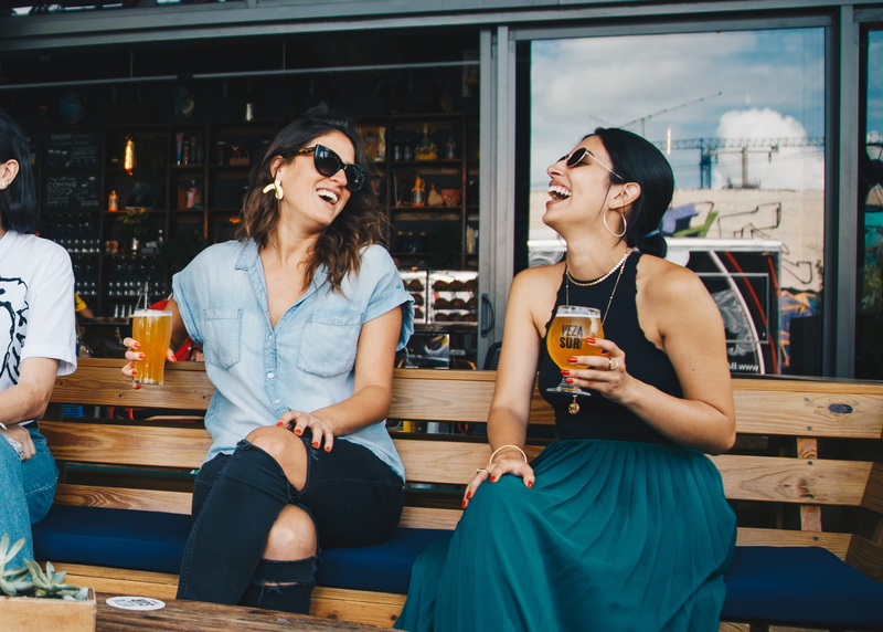 drink, people, sitting, drinking, adult, leisure, food and drink, smiling, real people, recreation, three quarter length, business, bar, happy hour, refreshment