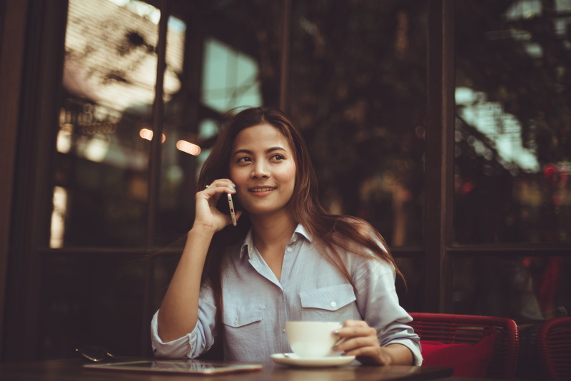 cup, food and drink, drinking, beautiful woman, call, dine, woman, smiling, connection, business, lifestyles, communication, restaurant, mug, one person