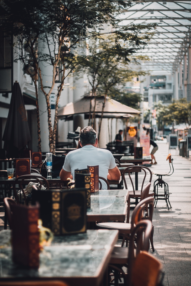 photo, bar, table, architecture, men, street, beside, building, outdoors, city life, plant, incidental people, built structure, man, tree, building exterior
