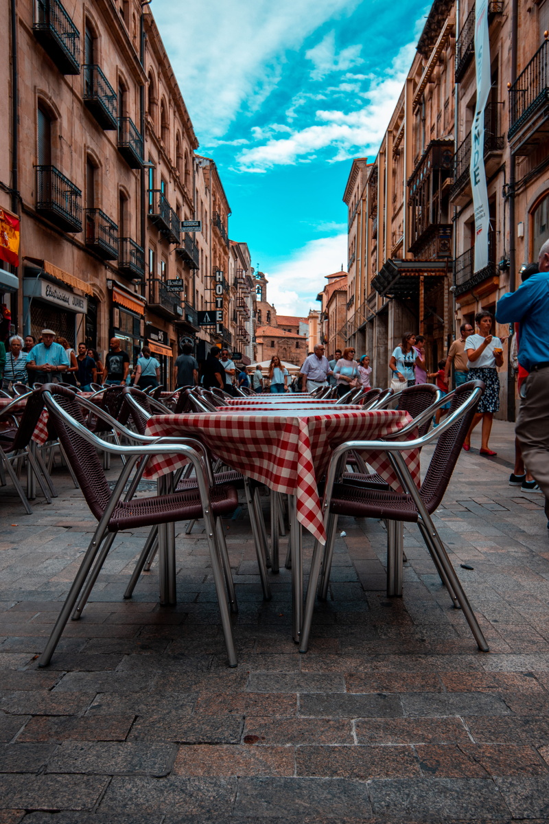dining table, spain, architecture, incidental people, walkway, building exterior, 5K, cloud - sky, set, cafe, sidewalk cafe, built structure, performer