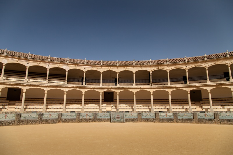blue, stage theater, beige, day, bullfight, culture, matador, building, the past, sport, clear sky, daytime, movie theater, arena, sky, travel, entertainment