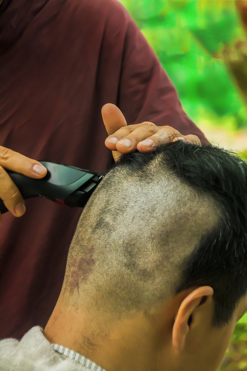 buddhism, pets, focus on foreground, 4K, shave, shaving hair, theravada buddhism, real people, care, monastery, human hand, spiritual, ordination, shaving