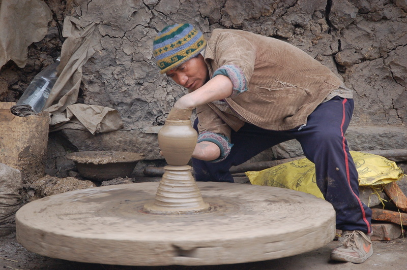 one person, pot, craft, pottery, day, arts and crafts, dirt, clay, skill, real people, man, clothing, men, full length, potter, potters, nepal, mud, side view