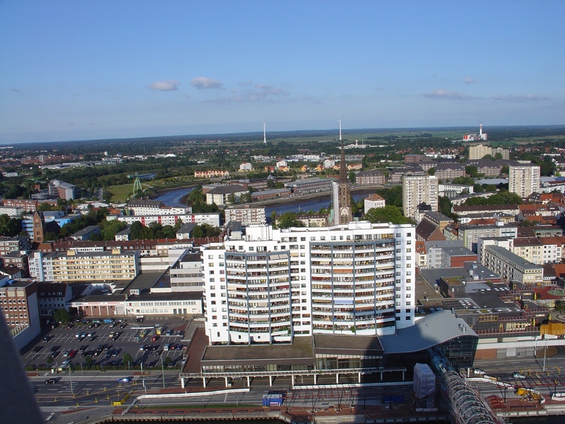 crowded, columbus center, building exterior, skyscraper, high angle view, 2K, crowd, sea, day, built structure, horizon over water, outdoors, office building exterior
