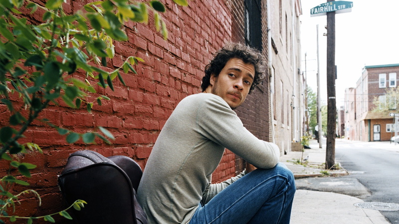 people, house, urban Scene, chair, three quarter length, lifestyles, gray, building Exterior, brick wall, sitting, looking at camera, built structure, wall
