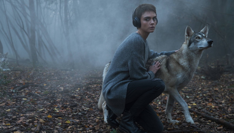 land, headphones, young adult, dog, one animal, tattoo, women, tree, day, looking at viewer, one person, nature, contemplation, leisure activity, outdoors