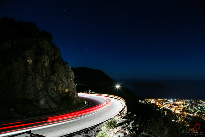 landscape, road, mode of transportation, tail light, speed, long exposure, sky, sea, mountain, star - space, night, light trail, light, motion, transportation