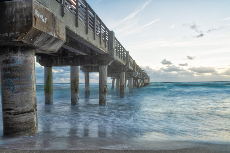 no people, water, handrail, underneath, boardwalk, clothing, bridge, flowing water, waterfront, day, motion, outdoors, shoreline, ocean, beach, dock, horizon