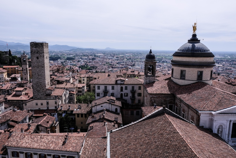 roof tile, bergamo, crowded, italy, tourism, outdoors, building exterior, sky, religion, belief, townscape, spirituality, residential district, city, spire