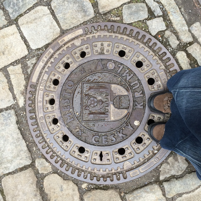 high angle view, lifestyles, standing, personal perspective, republic czech, cesky krumlov, shape, real people, low section, street, human foot, sewer