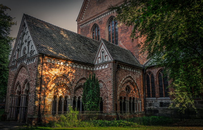 low angle view, tree, architecture, building, window, arch, the past, brick, nature, history, sky, facade, building exterior, spirituality, religion, place of worship