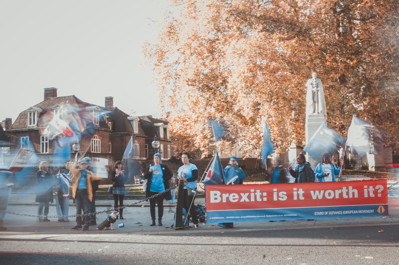 worth, apparel, outdoors, road, communication, text, person, daytime, city, sky, street, tarmac, real people, asphalt, day, banner, elk, lifestyles, wildlife