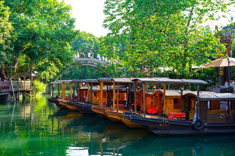 plant, incidental people, moored, houseboat, 4K, outdoors, boat, boating, wuzhen, waterfront, transportation, antiquity, mode of transportation, building exterior