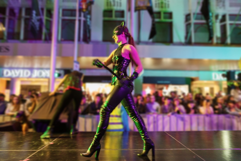 8K, incidental people, crowd, lifestyles, runway, arts culture and entertainment, focus on foreground, enjoyment, stage - performance space, cat woman