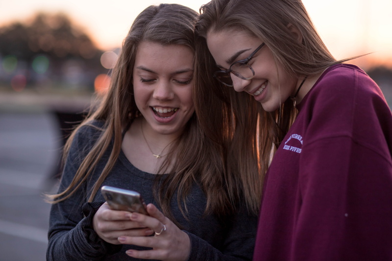 leisure activity, communication, accessory, smartphone, person, laughing, teenagers, focus, selective, black, electronics, technology, youth, cell phone