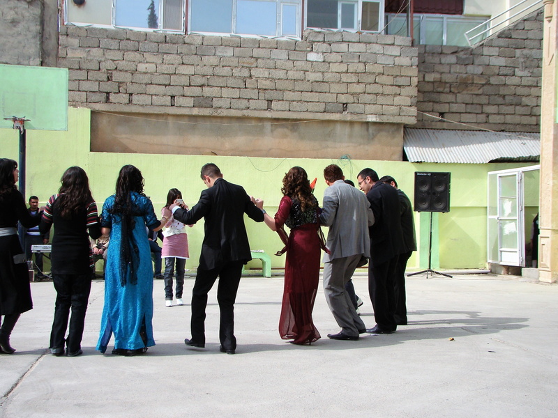 group, casual clothing, dance, adult, city, folk dance, building exterior, day, lifestyles, building, full length, kurdistan, women, communication, people
