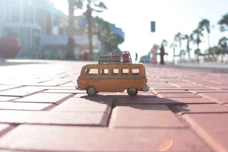 aruba, sunlight, architecture, footpath, selective focus, toy collection, car, surface level, incidental people, outdoors, 4K, shadow, toy cars, paving stone