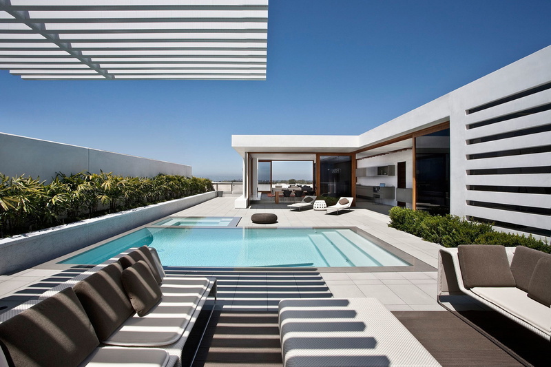 sofas, building exterior, patio, sky, table, no people, clear sky, blue, interior, wealth, swimming pool, exterior, chairs, luxury, nature, residential district