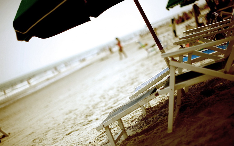 built structure, umbrella, architecture, motion, sea, outdoors, Beach, sunbeds, tilt, selective focus, sun, loungers, day, land, sand, wood - material