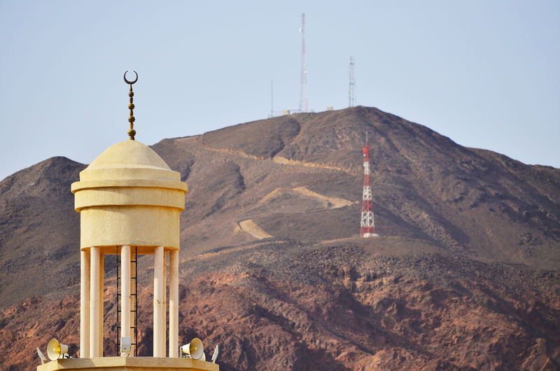 medina, tower, outdoors, place of worship, mosque, building, mountain, road, dome, built structure, masjid, belief, day, religion, no people, nature, islam