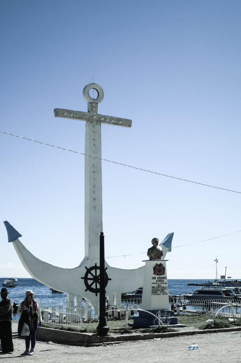 real people, nautical vessel, men, group of people, cross, sea, sky, religion, bolivia, copacabana, landmark, statue, outdoors, day, nature, blue, water