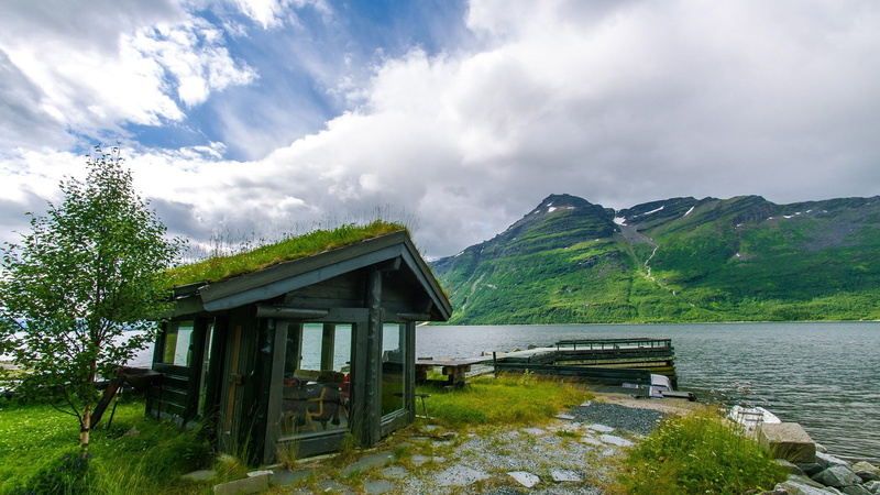 sea, beauty in nature, grass, residential, home, mountain, boathouse, non-urban scene, cottage, real, sky, tree, no people, house, window, travel, life