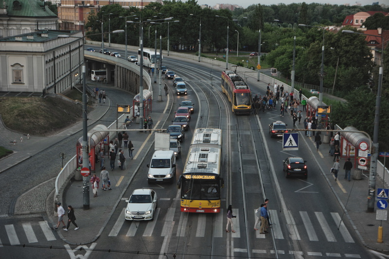 high angle view, incidental people, warsaw, built structure, road marking, street, city, transportation, sign, city life, poland, bus, outdoors, traffic