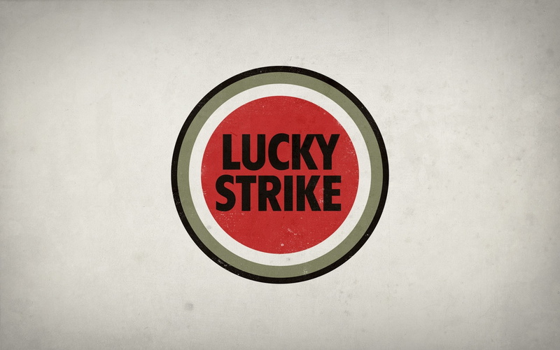 message, no people, information, Lucky Strike, circle, geometric shape, red, western script, logo, white color, wall, shape, indoors, sign, capital letter