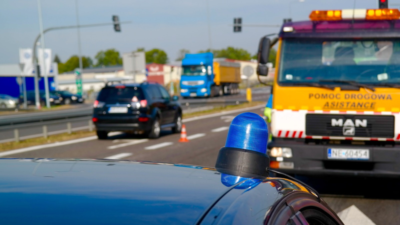 the police, outdoors, 5K, travel, poland, close-up, wheel, nature, day, sign, public transportation, focus on foreground, land vehicle, text, blue, city