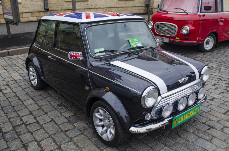 black, mode of transportation, motor vehicle, taxi, day, steering wheel, flag, no people, car, road, parking, retro styled, mini, driving, english, city