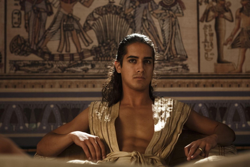 tut, adult, one person, history, beautiful people, Tut (TV Mini-Series 2015– ), hairstyle, sitting, lifestyles, tv series, indoors, young women, looking at camera