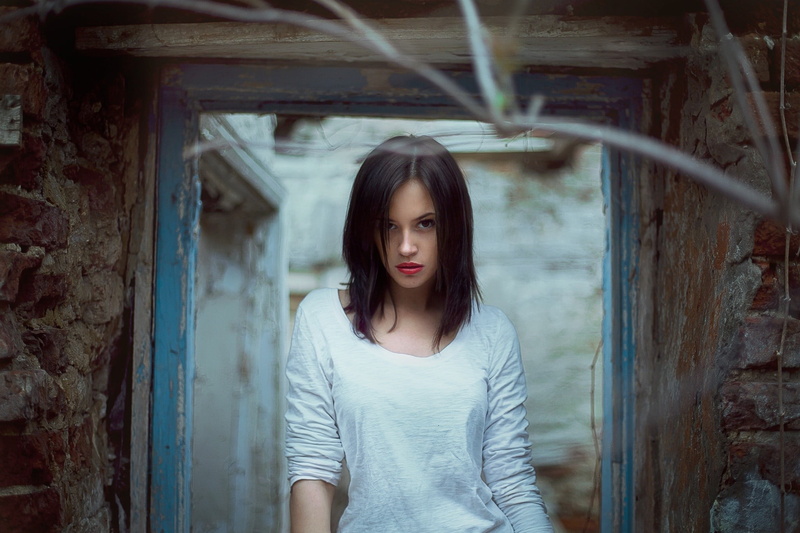 young adult, real people, hairstyle, front view, architecture, standing, casual clothing, contemplation, long hair, ruins, lifestyles, adult, young women