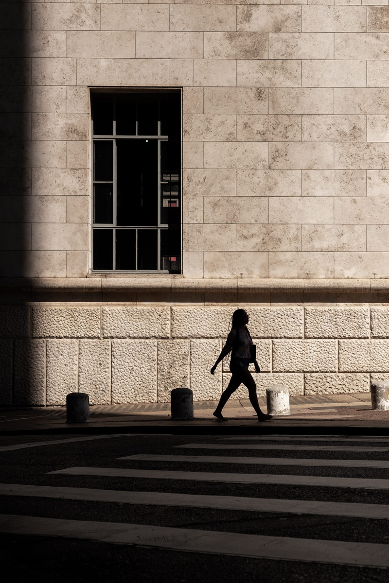 shadow, architecture, near, wall, built structure, footpath, one person, intersection, city, wall - building feature, building exterior, buildin, outdoors