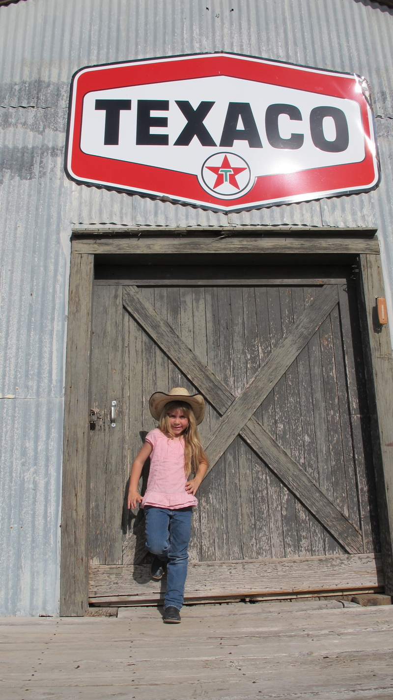 texaco, old west, girls, waiting, day, females, full length, western script, casual clothing, door, outdoors, text, women, one person, architecture, gasoline company