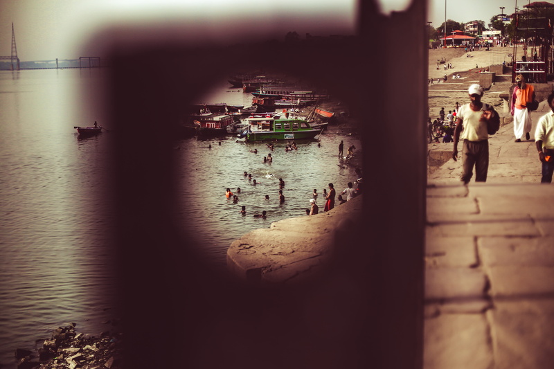 architecture, real people, spiritual family, building exterior, varanasi, outdoors, incidental people, look through hole, built structure, ganges, family