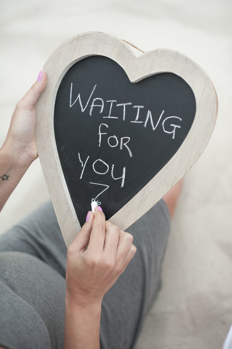 waiting for you, new parents, lifestyles, hand, communication, human finger, chalkboard note, one person, real people, body part, heart, expecting, love