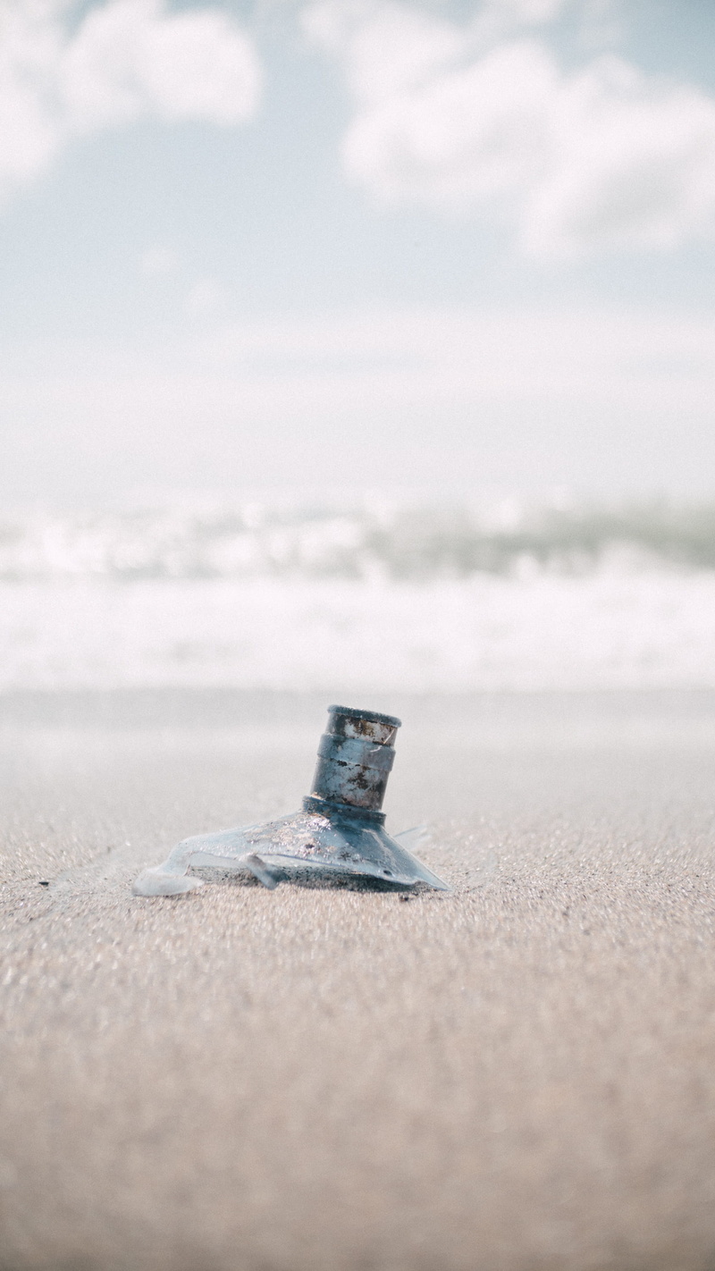 sky, metal, surface level, single object, close-up, beach, sign, communication, sunlight, water, cloud - sky, day, sea, sand, land, no people, beauty in nature